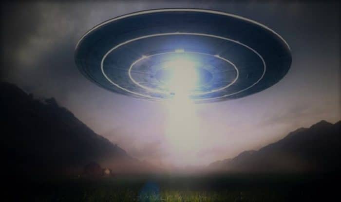 A depiction of a UFO in a mountain range 