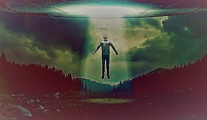 A depiction of a person being drawn into a UFO