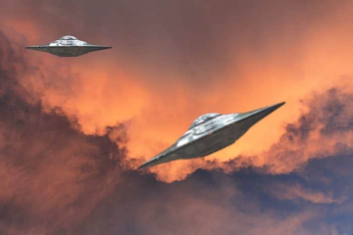 Two superimposed UFOs on a night sky