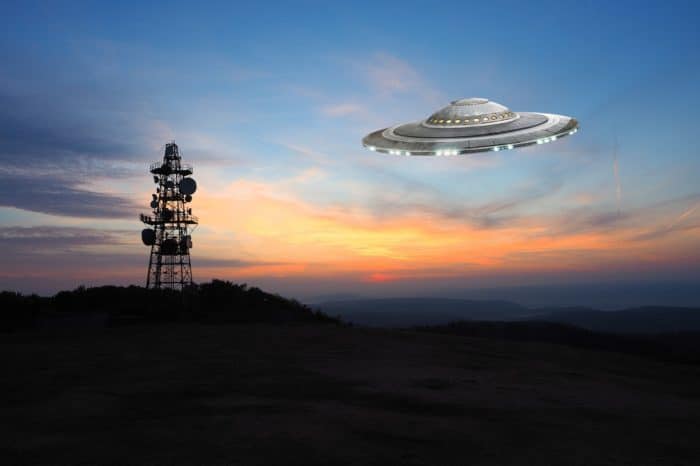 A superimposed UFO near a radio tower