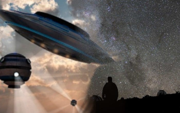 A blended picture of UFOs into a man looking at the stars