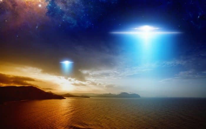 Depiction of two UFOs over the water