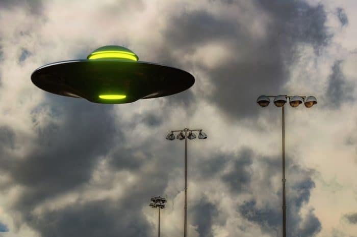 A depiction of a UFO in a cloudy sky