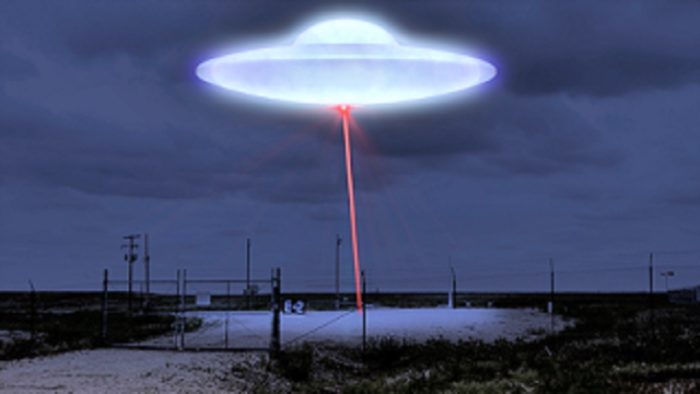 A glowing UFO with a red laser pointing to the ground