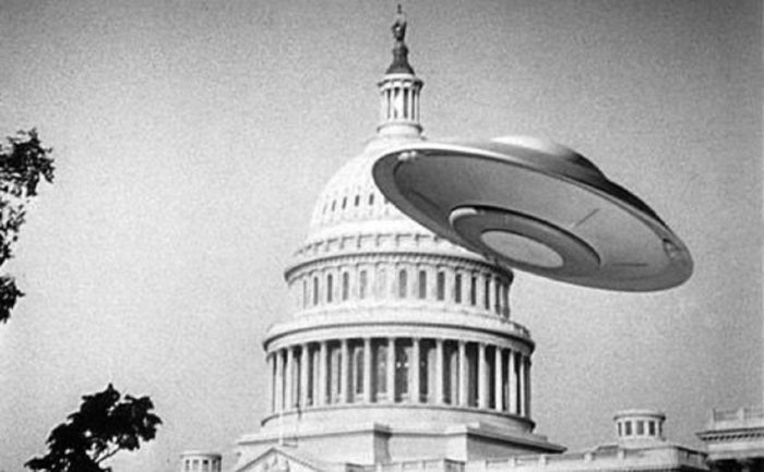 A depiction of a UFO over the Capitol Building