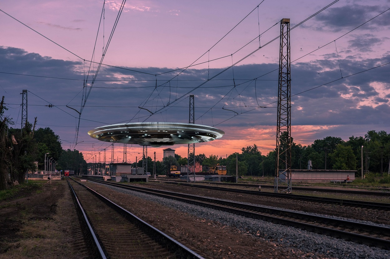 A depiction of a UFO over a railtrack