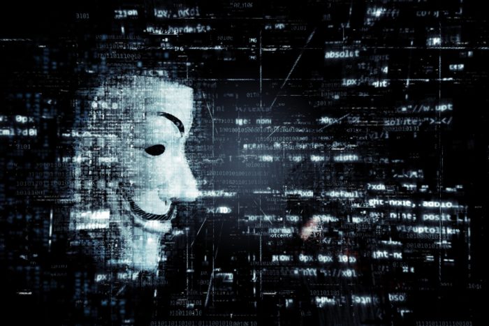 Anonymous mask looking at digital information