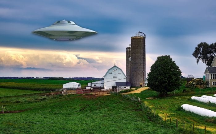 A depiction of a UFO over a field 