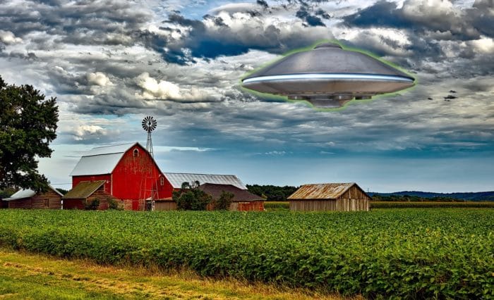 A depiction of a UFO over a farmer's field 