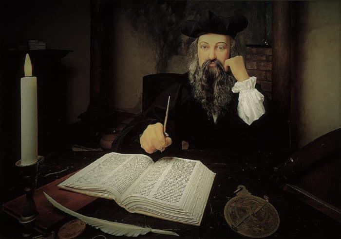 Picture of Nostradamus writing in a large book