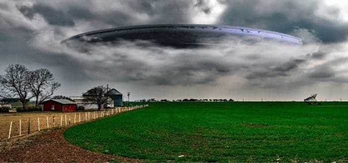 A superimposed UFO over a lonely field 