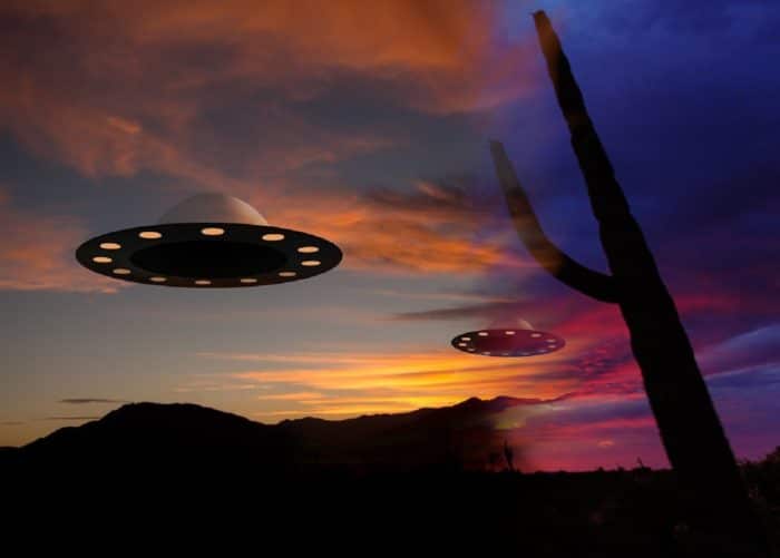 A depiction of a UFO over the desert