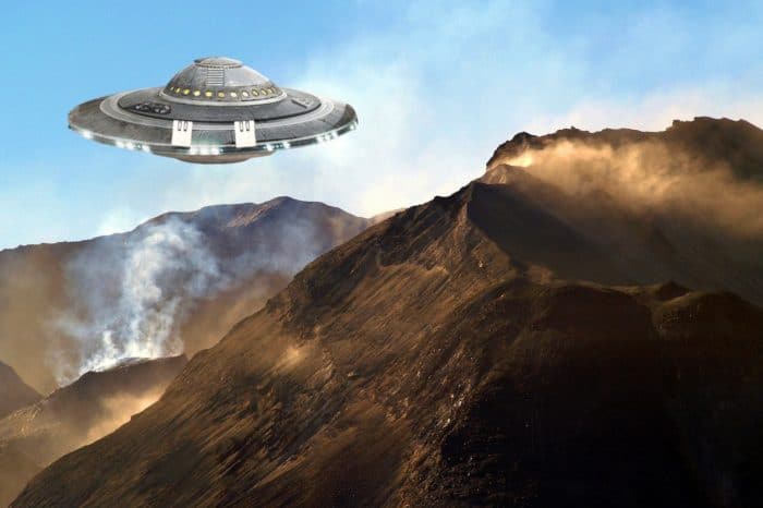 A depiction of a UFO over a mountain