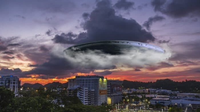 A depiction of a UFO emerging from clouds over a city