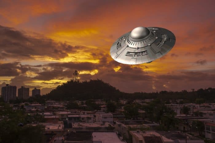 A depiction of a UFO over a city