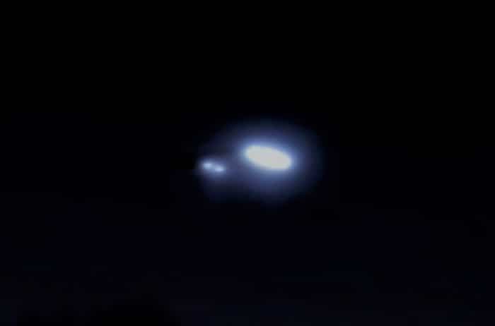 A depiction of a UFO in the night sky