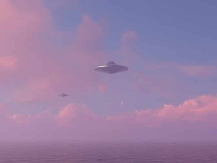 A depiction of two UFOs in a cloudy sky