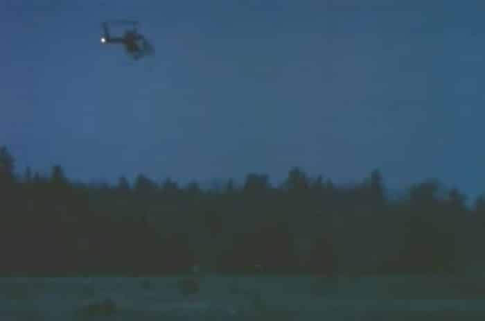 An image showing a mysterious helicopter over woodland