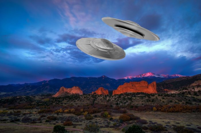 A depiction of UFOs over the mountains