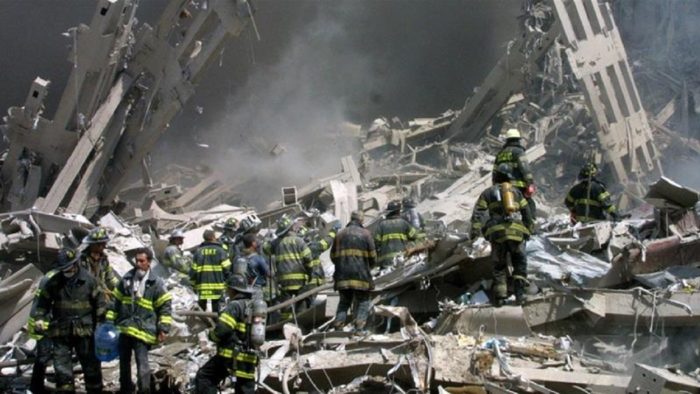 Emergency workers go through the rubble of the collapsed tower