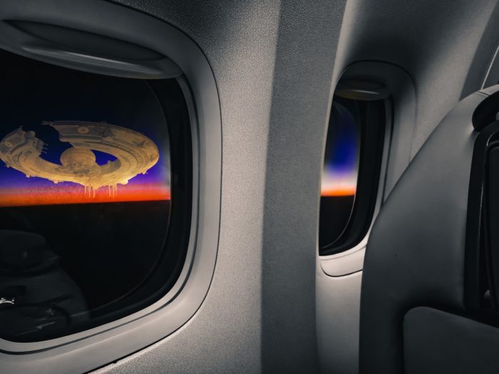 A depiction of a UFO outside the plane