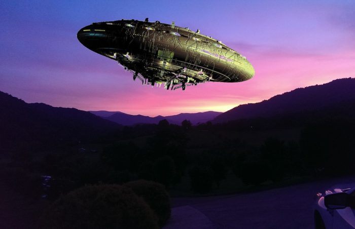 A superimposed UFO on a picture of the mountains at sunset