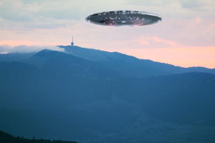 A superimposed UFO over a radio tower 