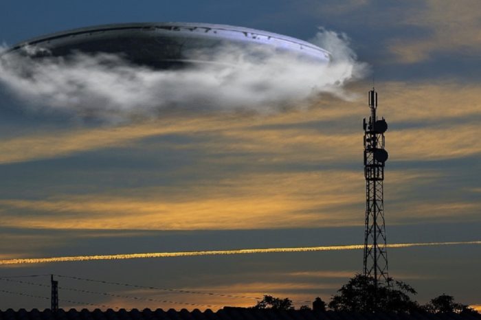 A superimposed UFO over a radio tower 