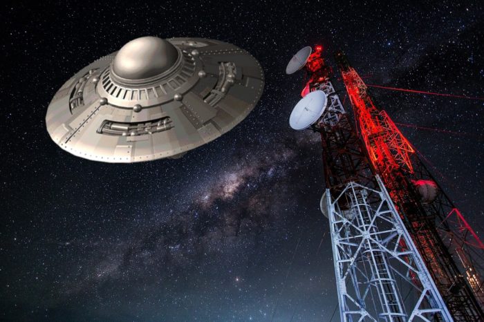 A depiction of a UFO over a radio tower