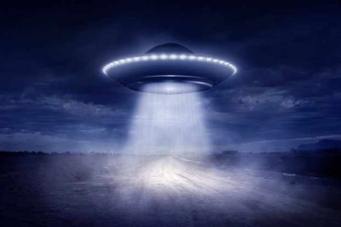 A depiction of a UFO over a field 