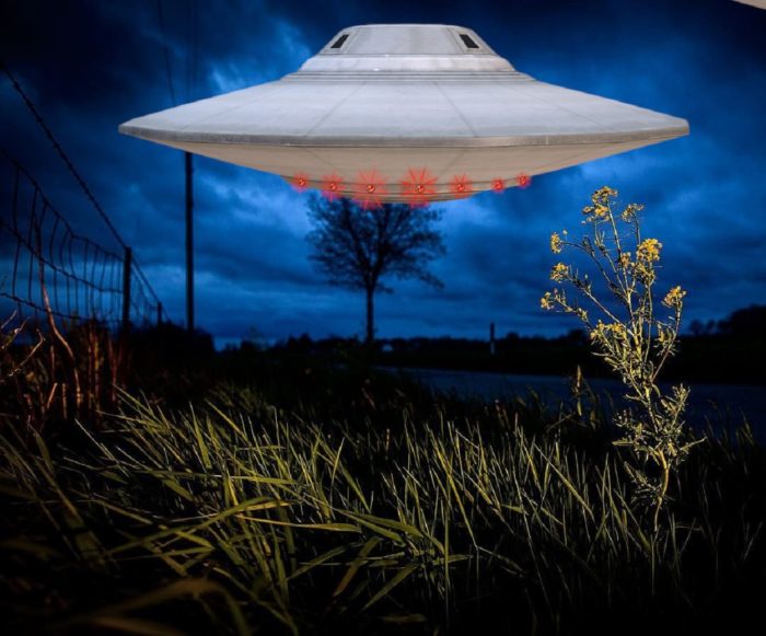 A depiction of a UFO over a river bank