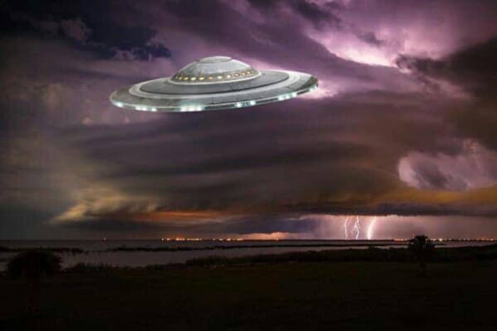 A superimposed UFO on a dark cloudy sky