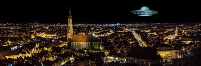 A superimposed UFO over a German city at night