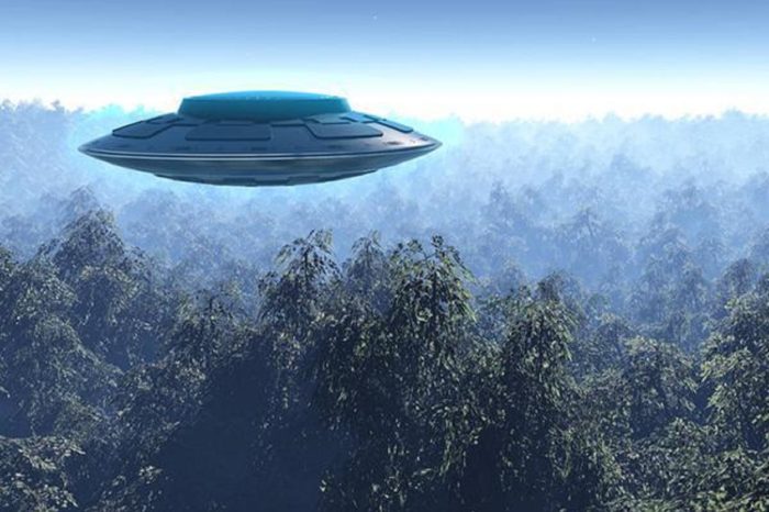 A depiction of a UFO high above a forest