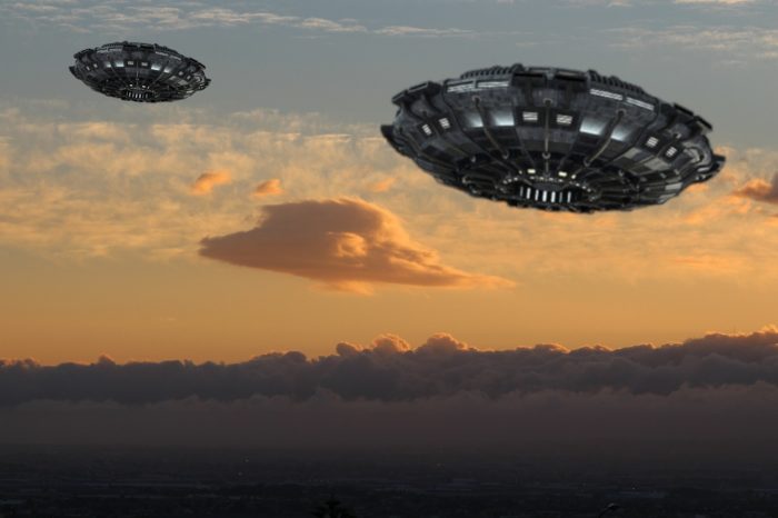 A depiction of two UFOs in a cloudy sky