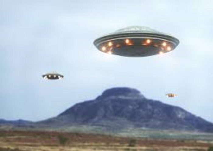 Superimposed UFOs over a mountain 