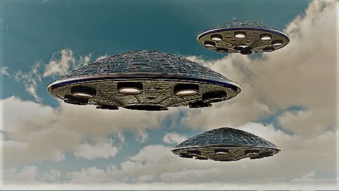 A depiction of three UFOs in a cloudy sky