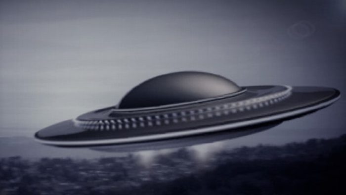 A depiction of a UFO flying over a city