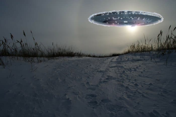 A superimposed UFO over a picture of a snowy hill