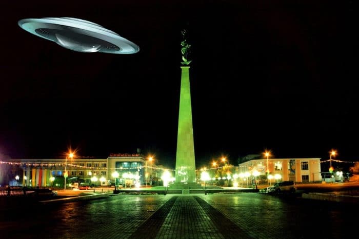 A superimposed UFO over a town square 
