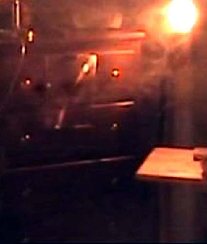 A picture claiming to show a grey alien in a bedroom