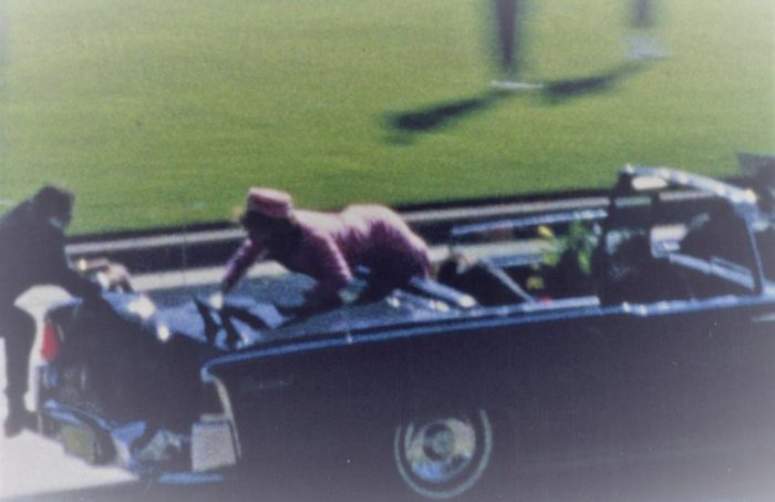 Jackie Kennedy attempts to leave the car moments after her husband was killed