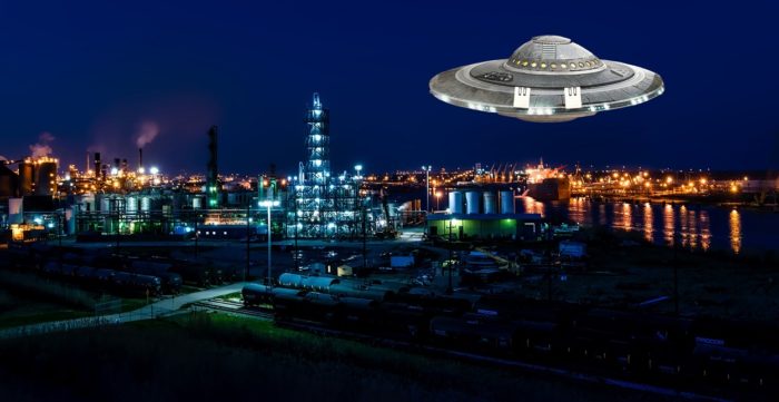 A superimposed UFO over an oil plant at night