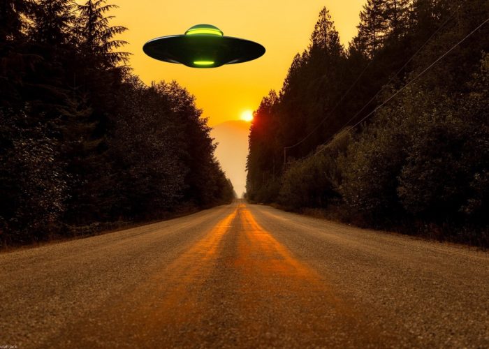 A depiction of a UFO over a lonely road at sunset