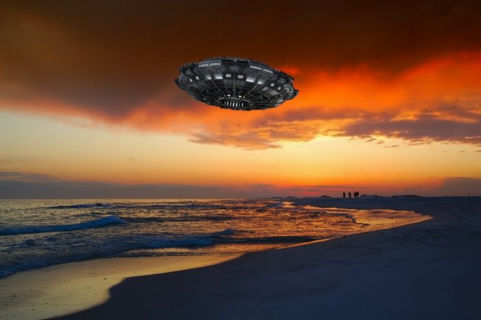 A depiction of a UFO over a beach at sunset