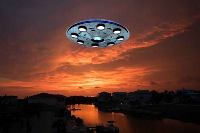 A superimposed UFO on a picture of a riverside community