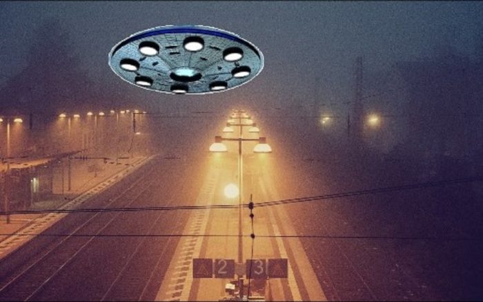 A UFO superimposed onto a picture of a misty train track