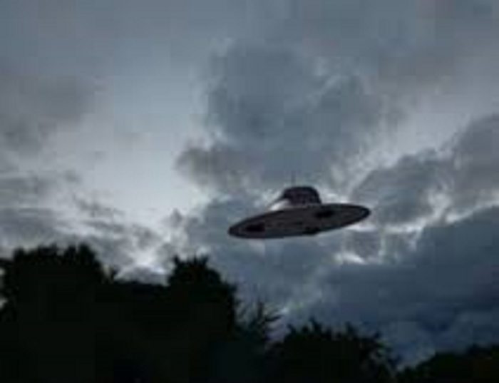 A depiction of a UFO in a dark, cloudy sky