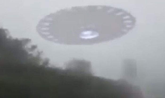 Impression of a UFO hovering in a misty sky