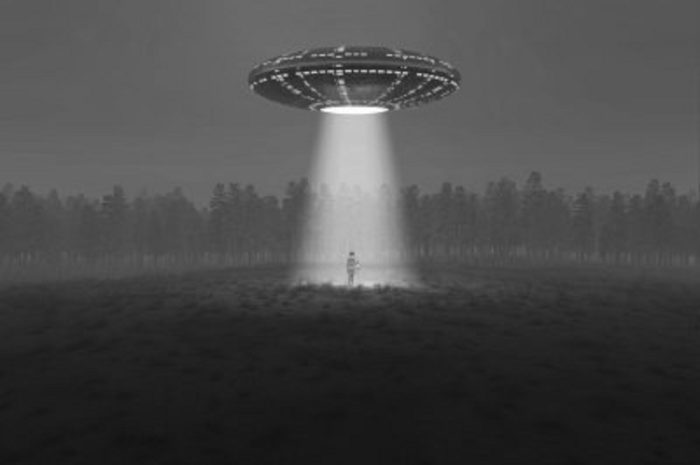 A depiction of a UFO shining a bright light into a field